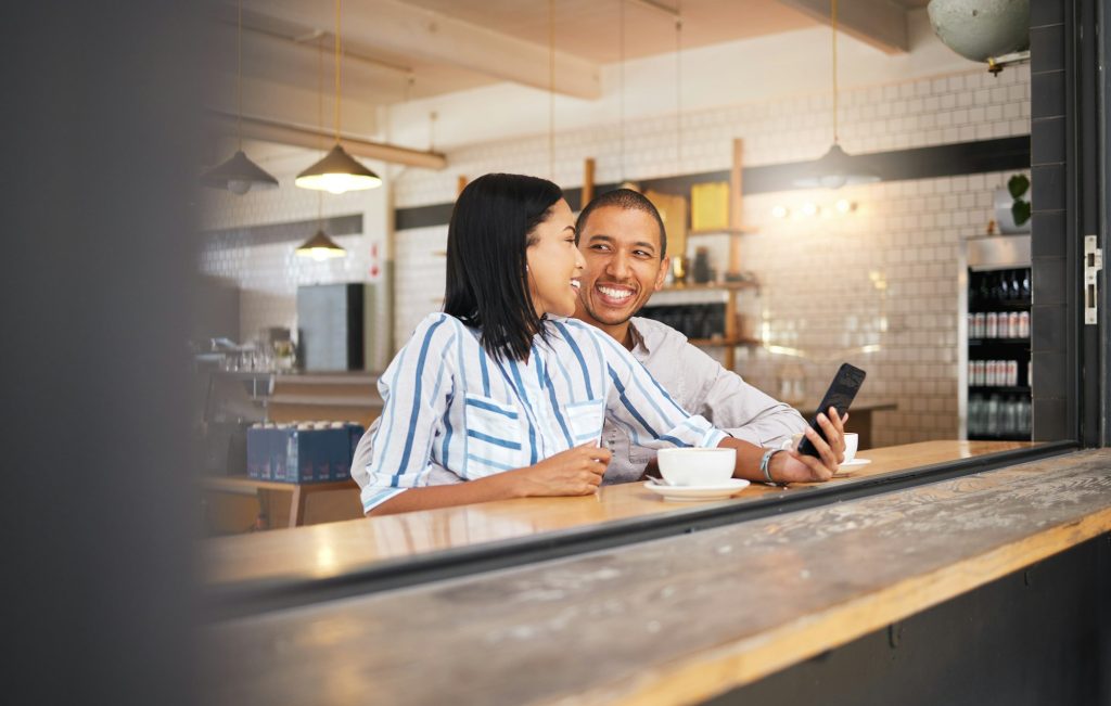 Couple phone selfie, love and cafe date in coffee shop or restaurant and bonding, enjoying free tim